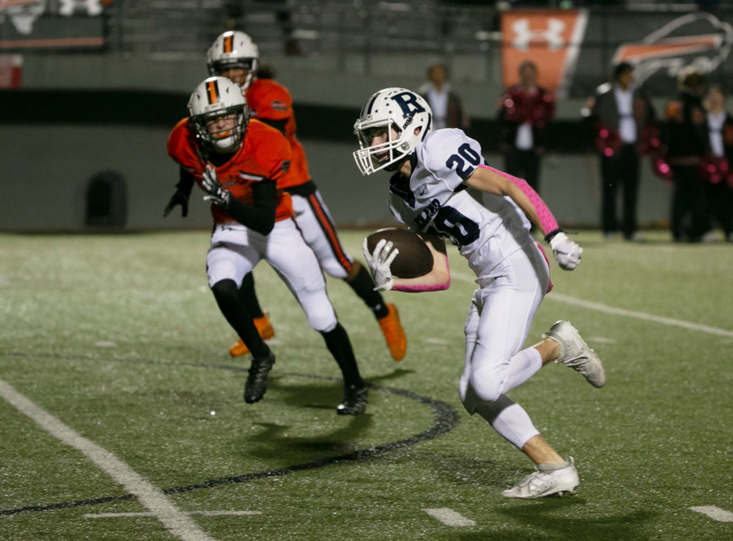 Richland's Slade Hamilton (20) break away from Haltom defenders as the ran for a touchdown...