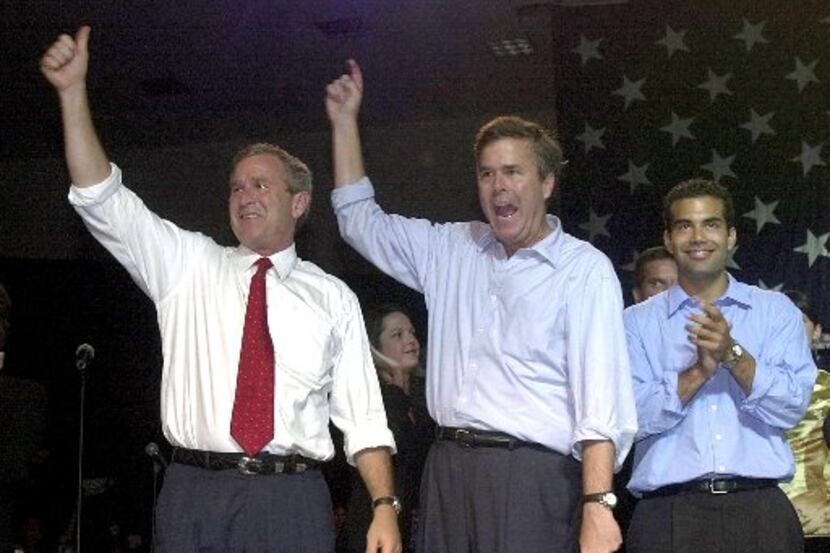 Texas Gov. George W. Bush, then running for president, with his brother, Florida Gov. Jeb...