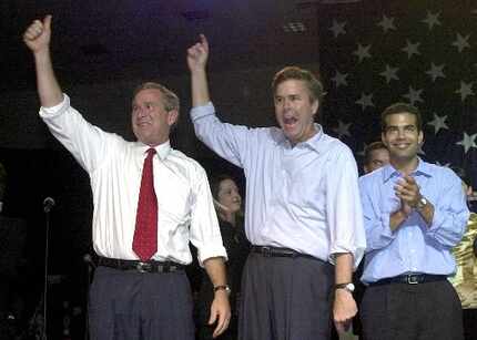 Then-presidential candidate George W. Bush, his brother, Florida Gov. Jeb Bush, and Jeb's...