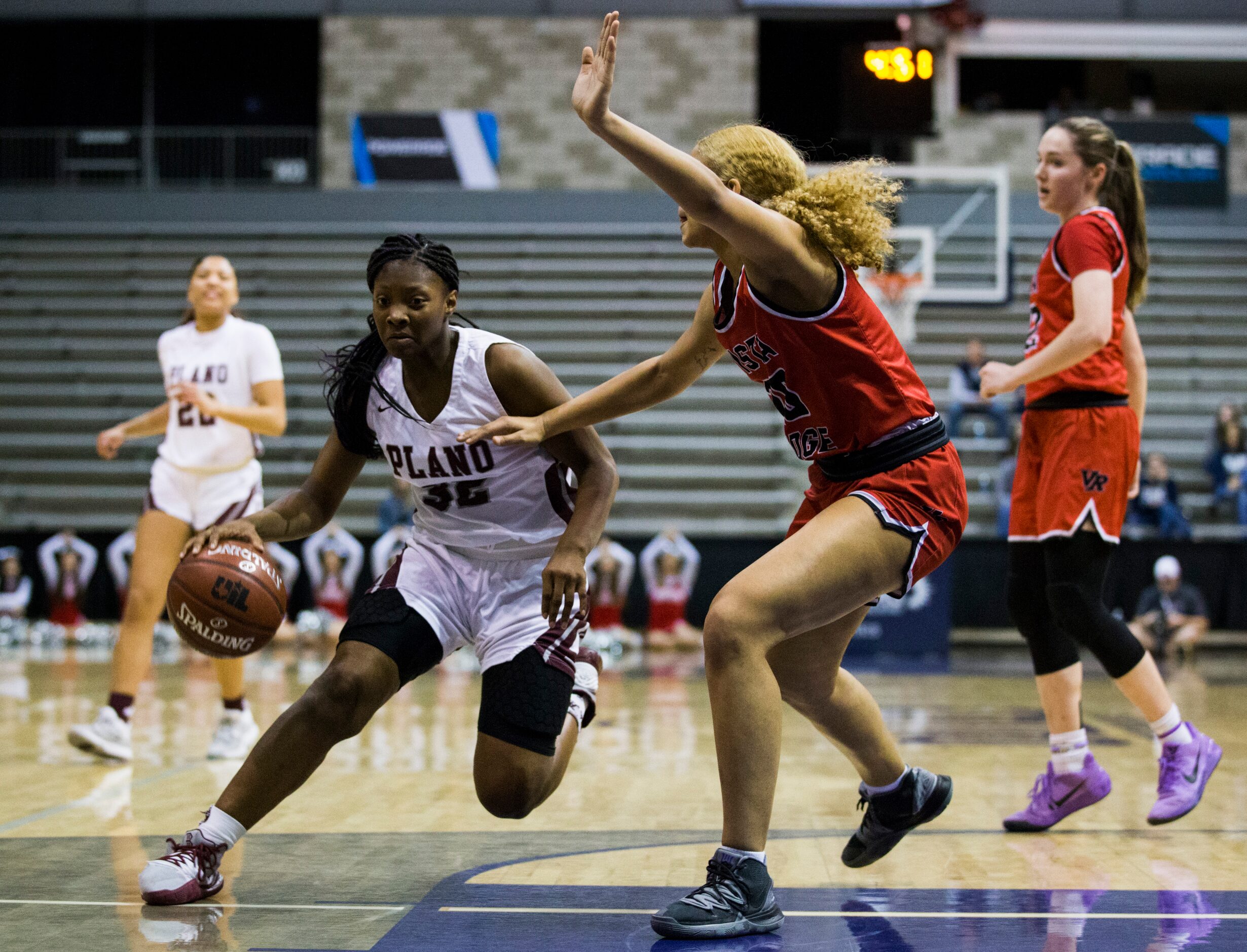 Plano guard Sanaa Murphy-Showers (32) gets past Cedar Park Vista Ridge forward Jazra...