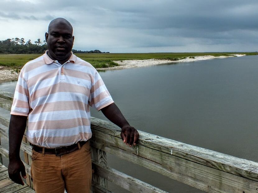 JR Grovner, a native of Georgia's Sapelo Island, stands on the pier where he greets guests...