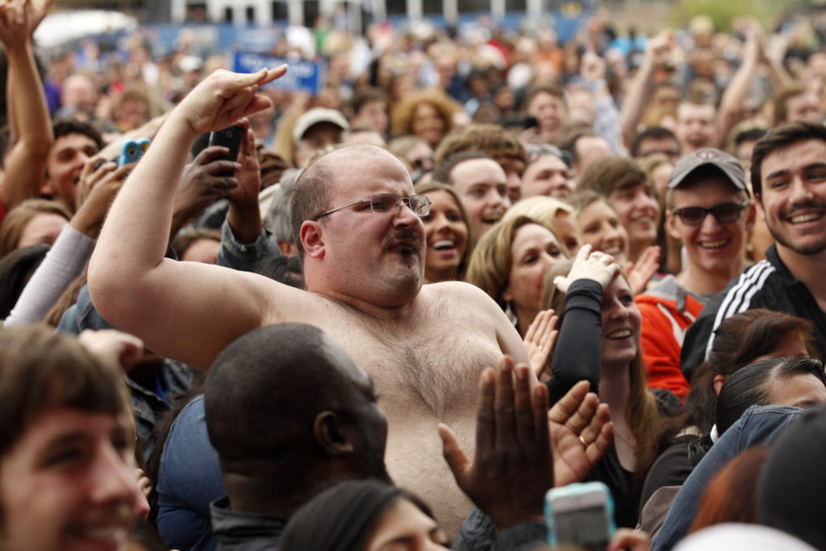 A concert goer takes of his shirt before the LL Cool J concert for the March Madness Music...