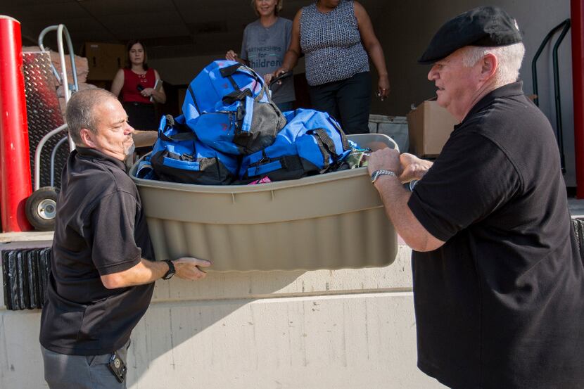Child Protective Services special investigators Tom Yarrington, left, and Don Frisch carry a...
