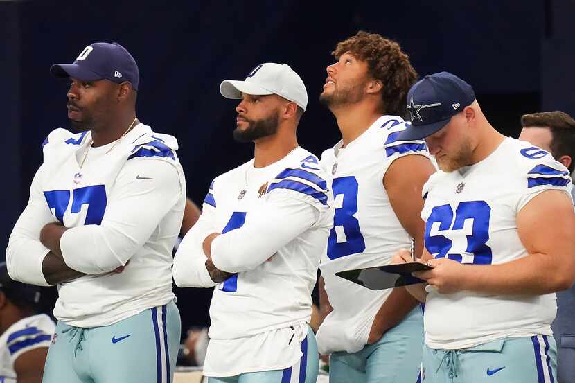 Dallas Cowboys quarterback Dak Prescott (4) watches from the sidelines with offensive...