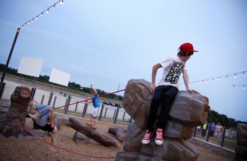 Cameron Frazier (right), 13, and other children tested out the facility’s playground....