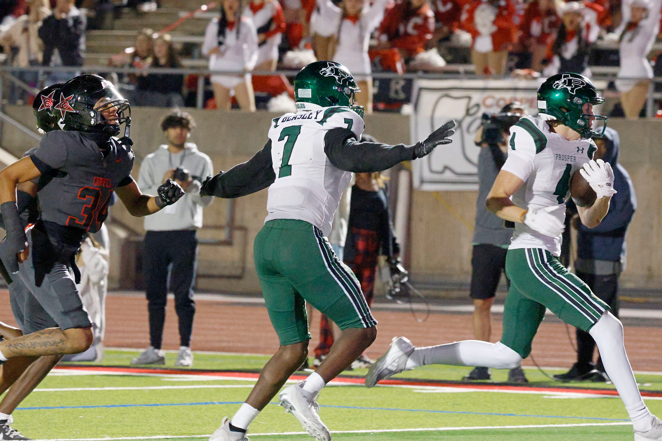 Prosper's Dallas Boozer (4) runs for a touchdown as Prosper's Jayden Beasley (7) and...