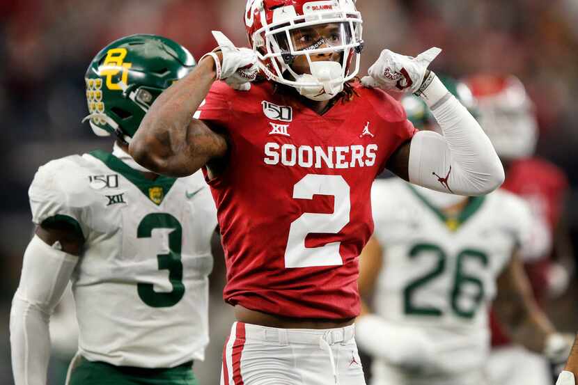 FILE - Oklahoma receiver CeeDee Lamb (2) flexes his muscles after taking a hit on a...