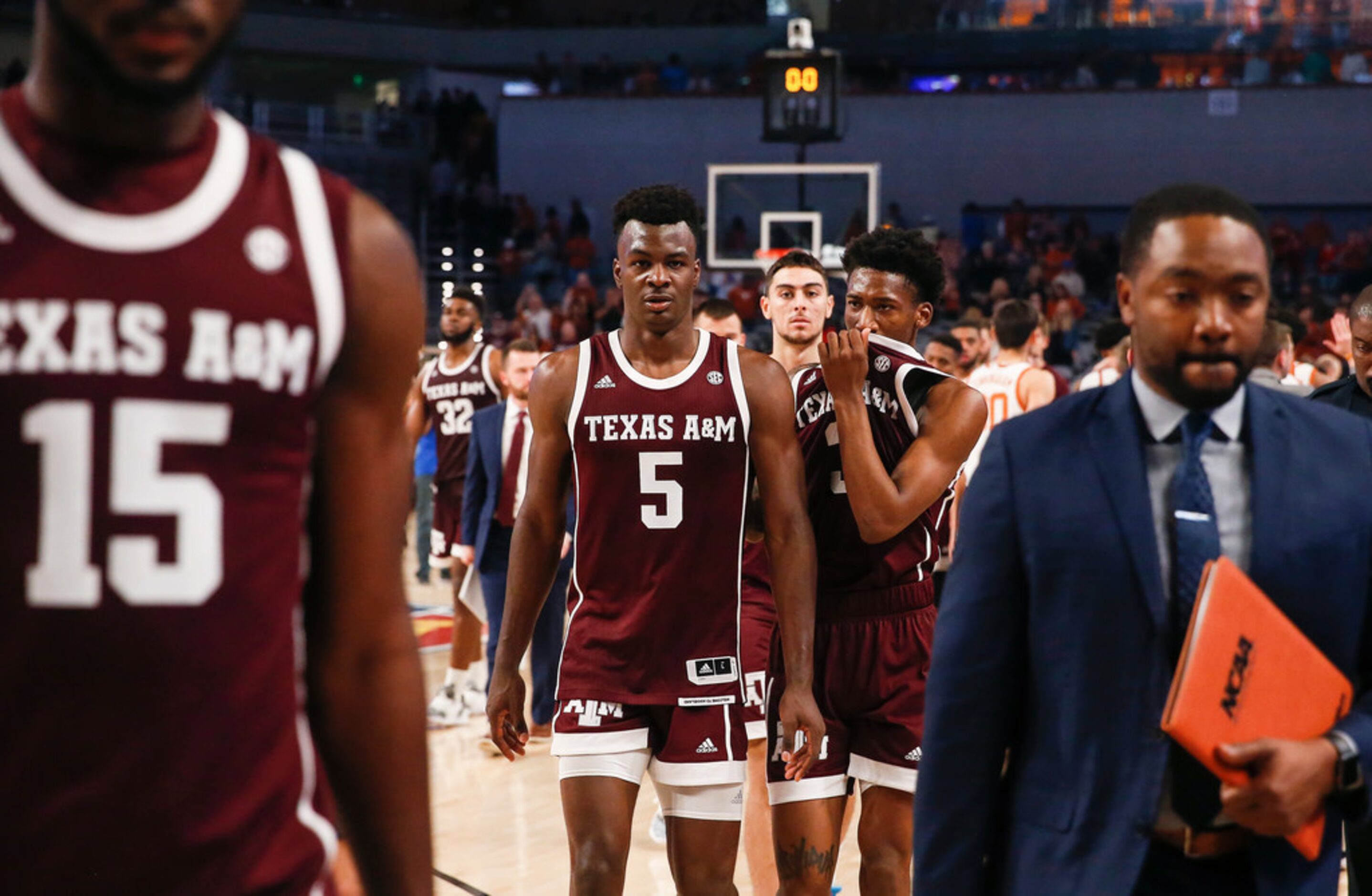 Texas A&M Aggies forward Emanuel Miller (5) and guard Quenton Jackson (3) exit the court...