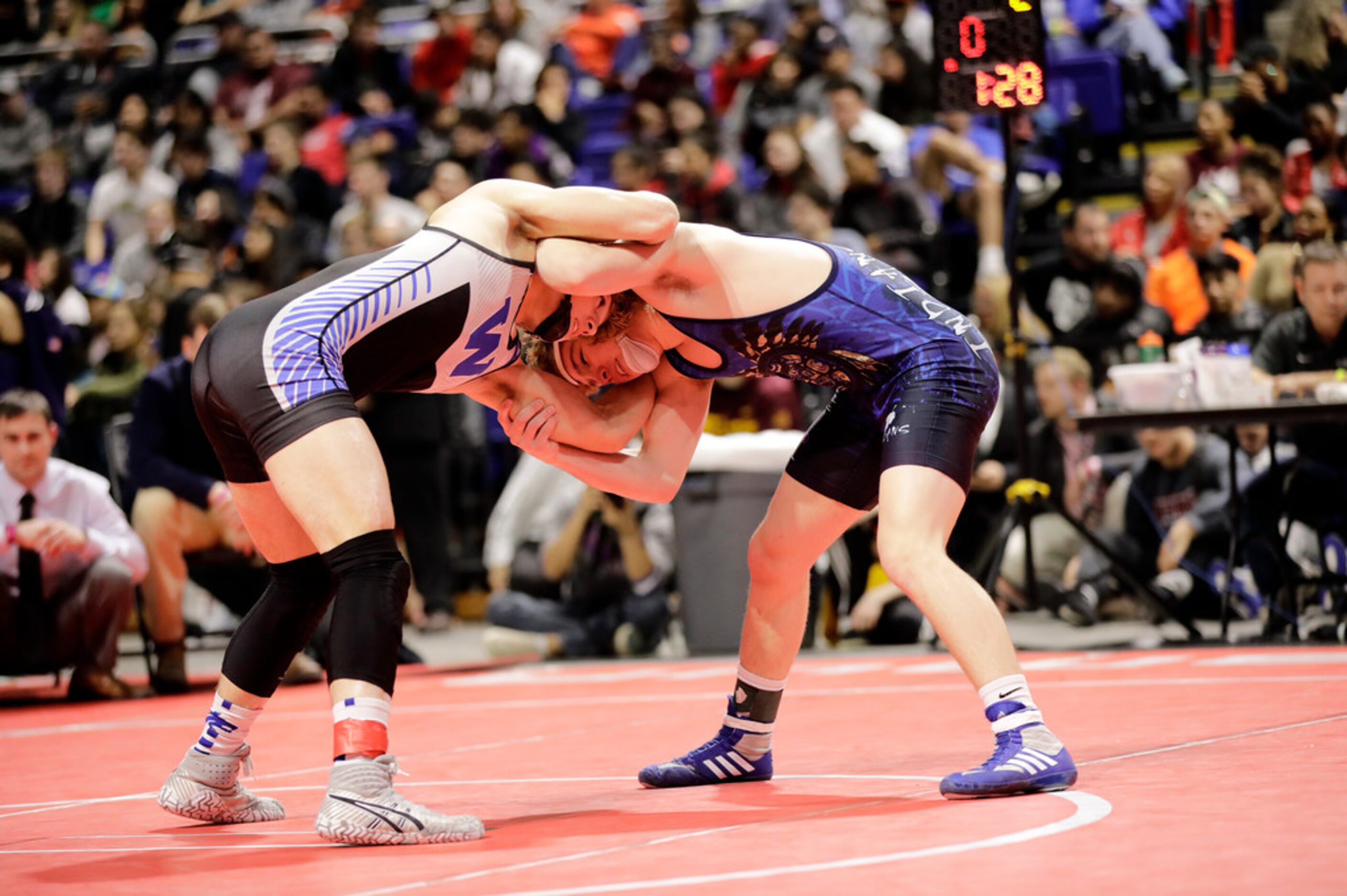 Parker Decker of Keller wrestles against Tagen Jamison of Plano West during the UIL Texas...