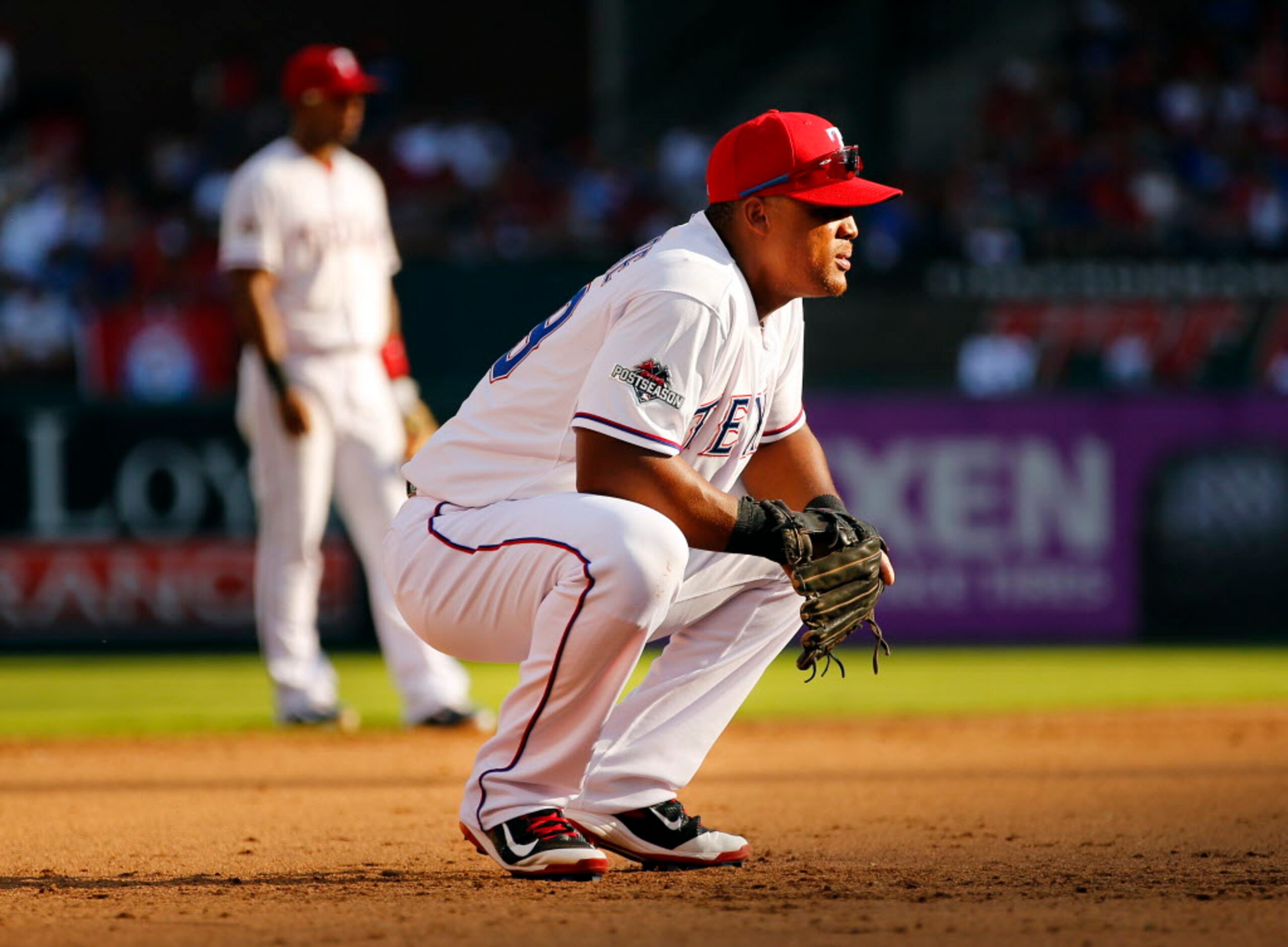 Texas Rangers third baseman Adrian Beltre (29) takes some stress off his back by squatting...