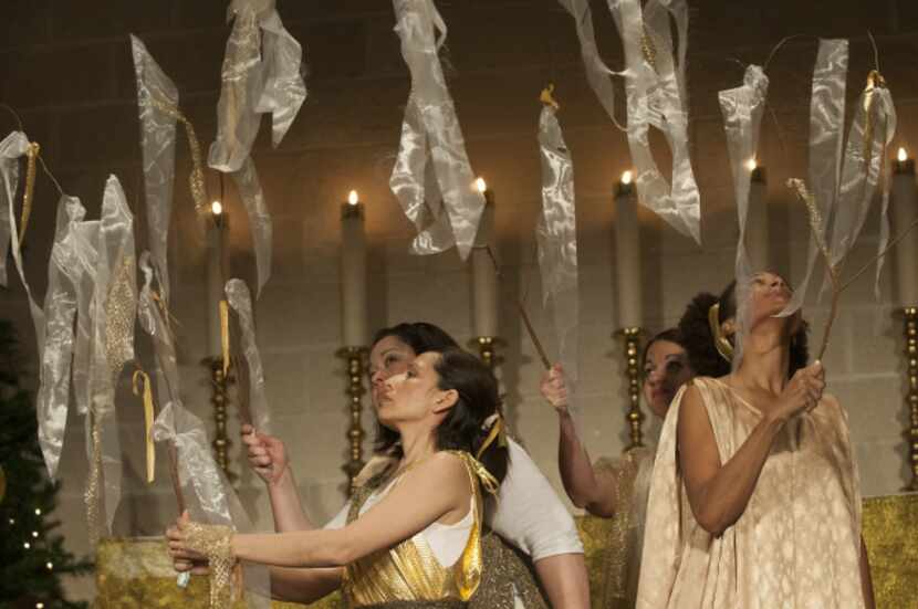 Dancers lit candles during their performance at the solstice celebration. The event drew a...