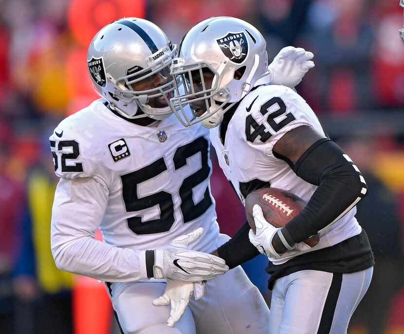 Oakland Raiders strong safety Karl Joseph is congratulated by defensive end Khalil Mack...