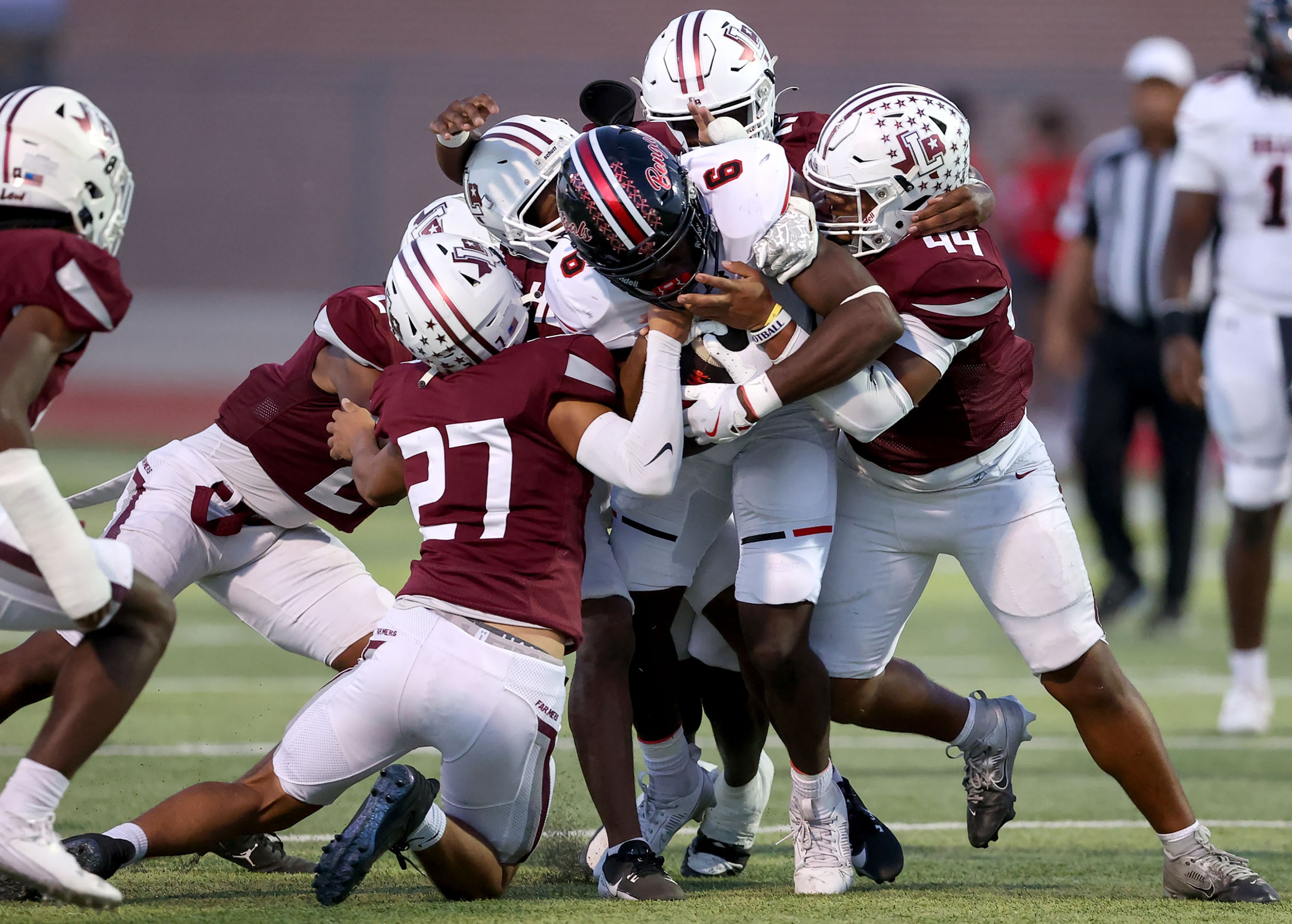 Denton Braswell running back Moses Adelowo (6) is stopped for a short gain by Lewisville...