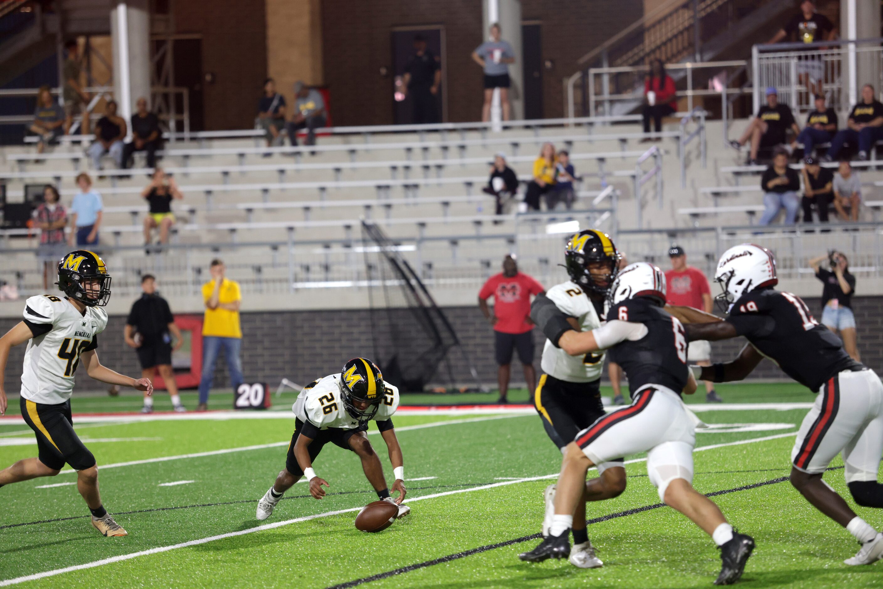 Memorial player #26 Edwin Parra tries to recover a fumble during an extra point attempt...