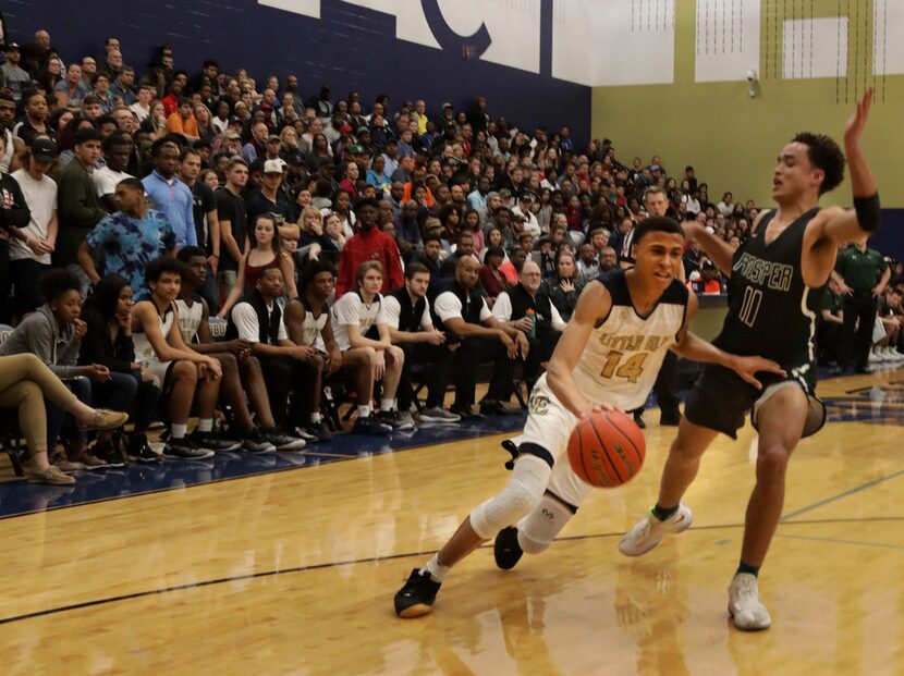 Little Elm player #14, RJ Hampton, drives past Prosper player #11, Josh Davis, during a...