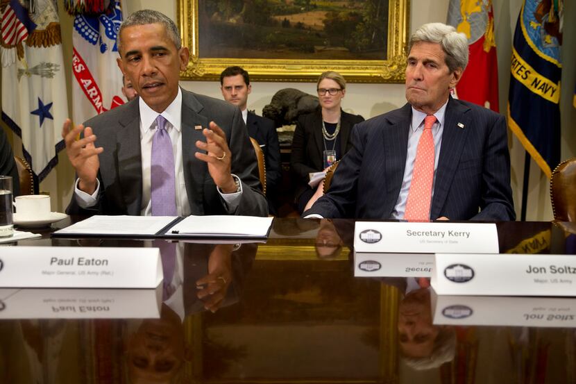 President Barack Obama and Secretary of State John Kerry speak at a meeting to discuss the...
