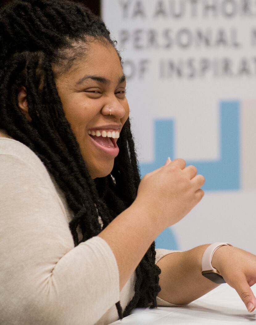 Author Angie Thomas laughs while participating in a panel discussion at the South Irving...