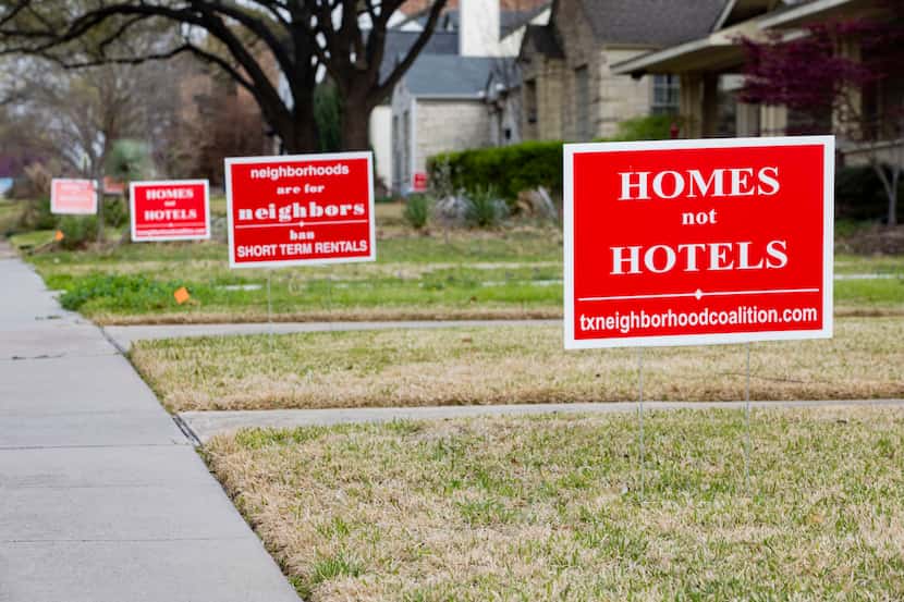 Bright red signs protesting short-term rental properties have been in place for weeks in the...