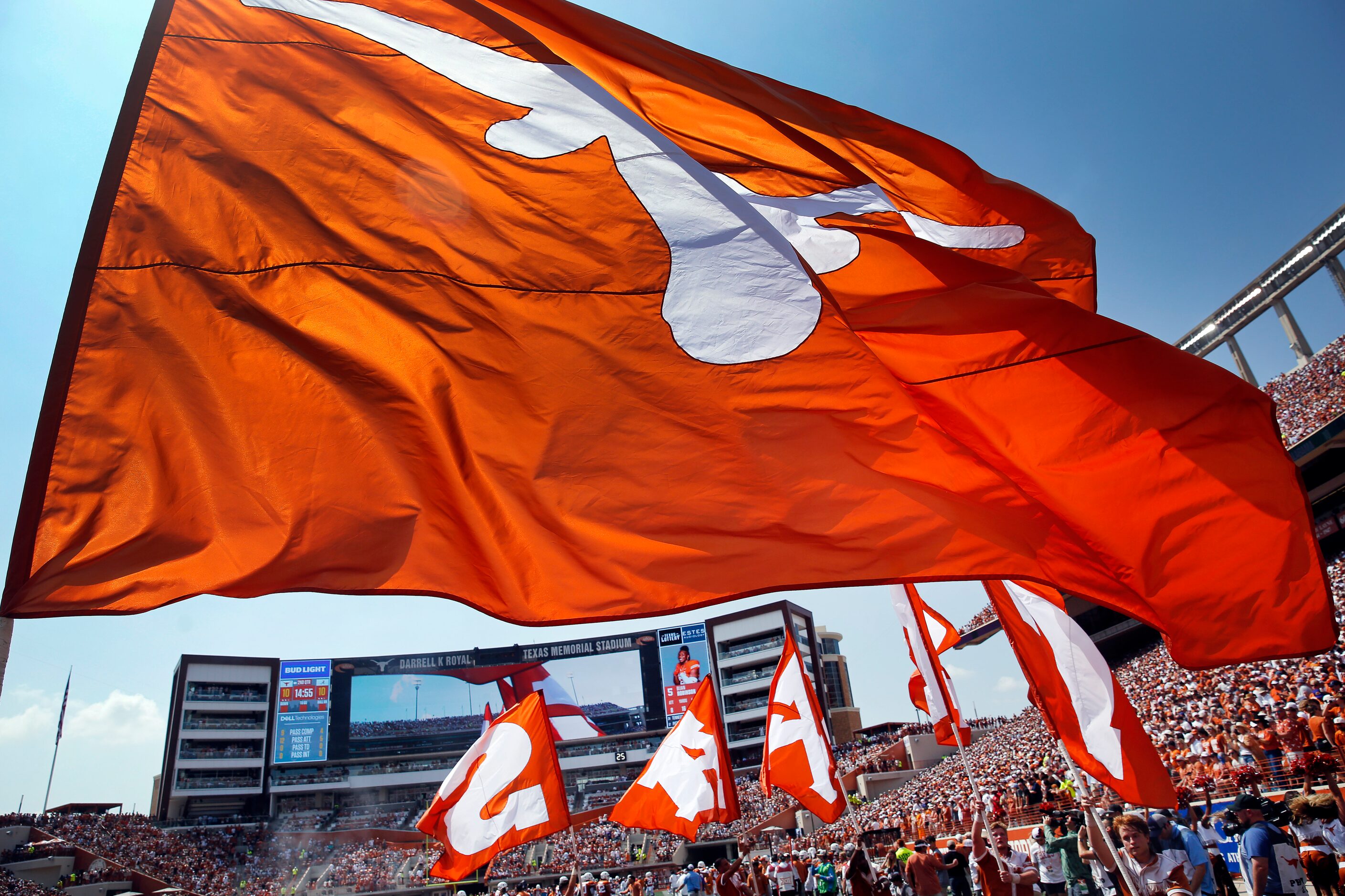 The flag bearers carry the Texas Longhorns colors and name following a first half sore...