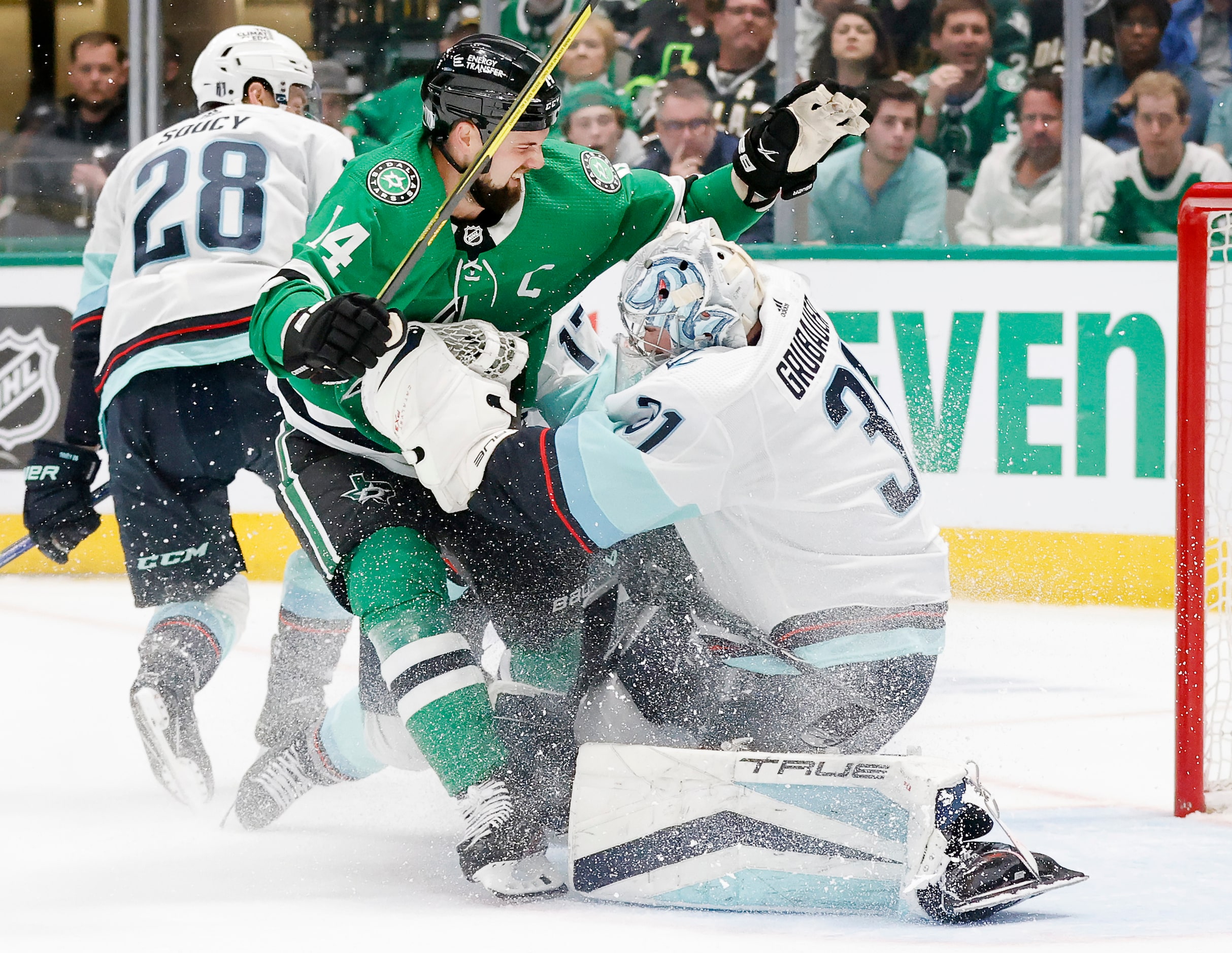 Dallas Stars left wing Jamie Benn (14) collides with Seattle Kraken goaltender Philipp...