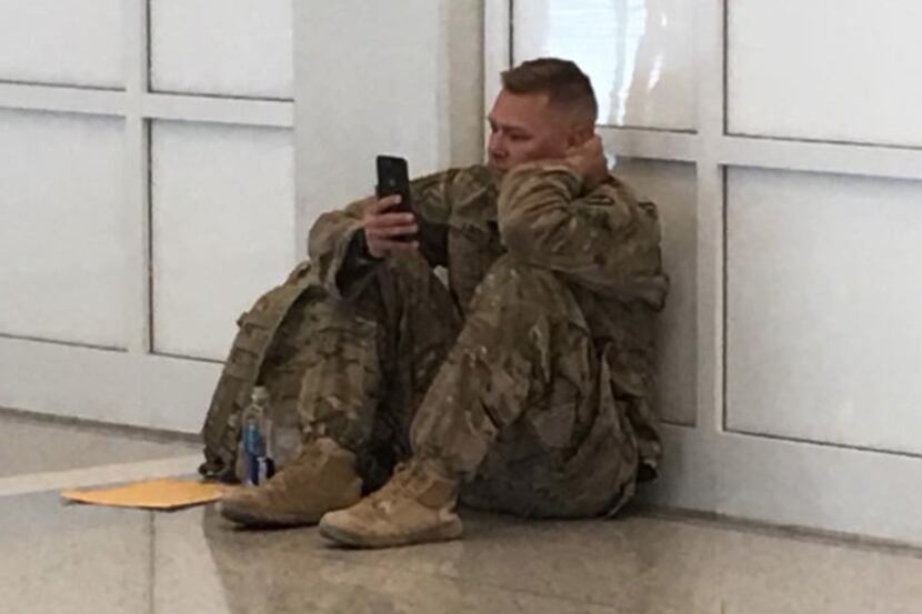 Soldier Brooks Lindsey, shown at DFW International Airport, watches on FaceTime as his wife...