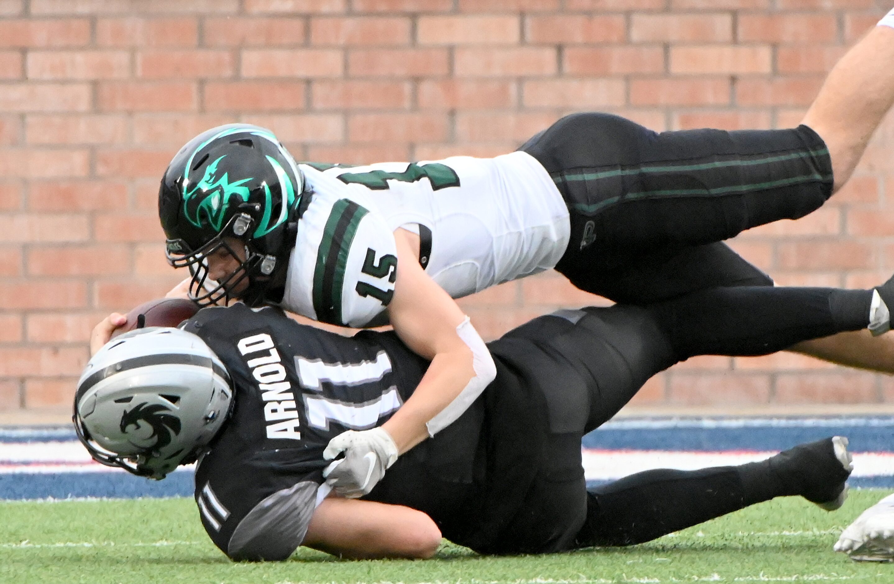 Prosper’s Graydon Splawn (15)sacks Denton Guyer's Jackson Arnold (11) in the second half of...