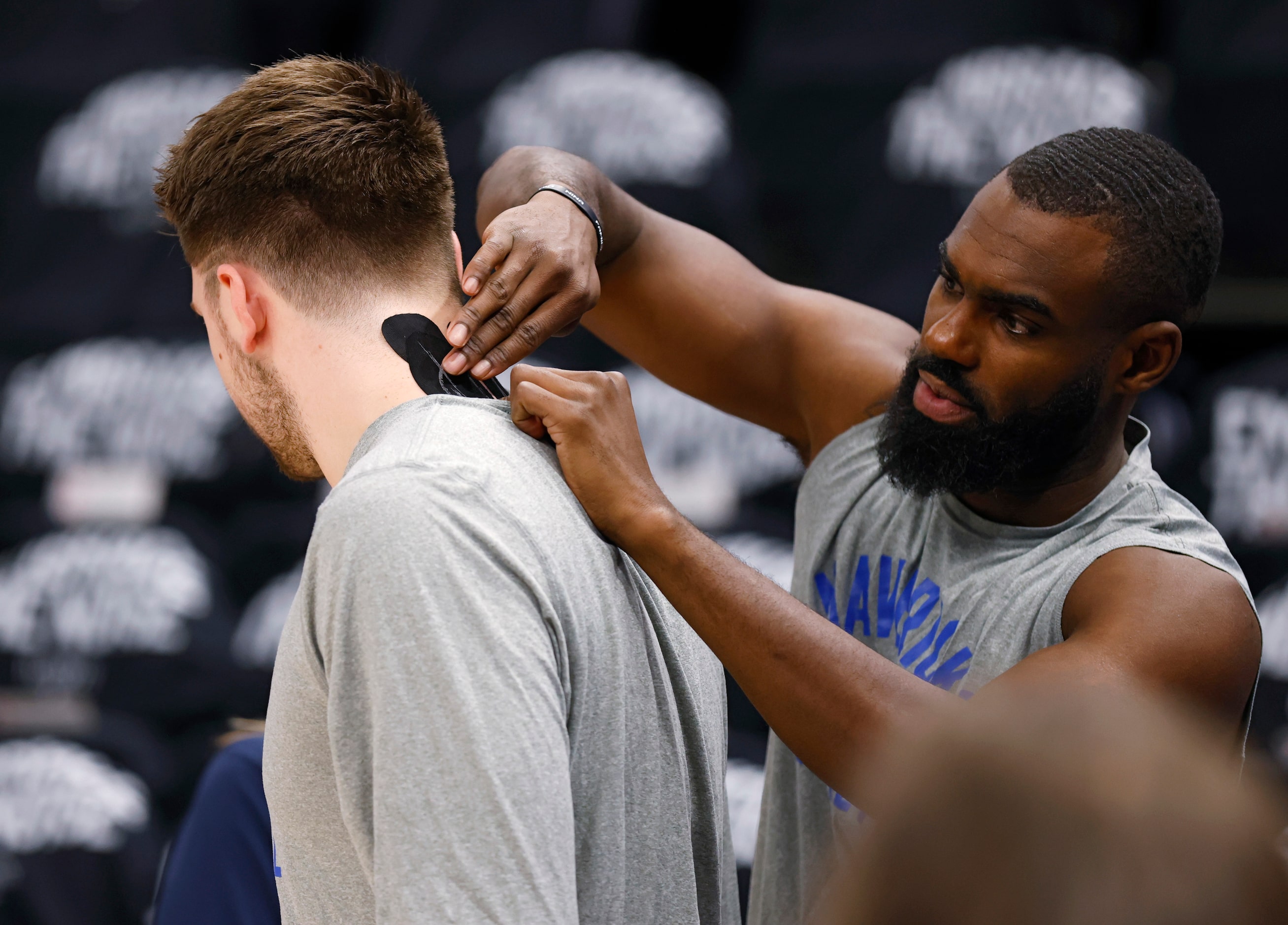 Dallas Mavericks forward Tim Hardaway Jr. (11) fixes the therapeutic tape that came undone...