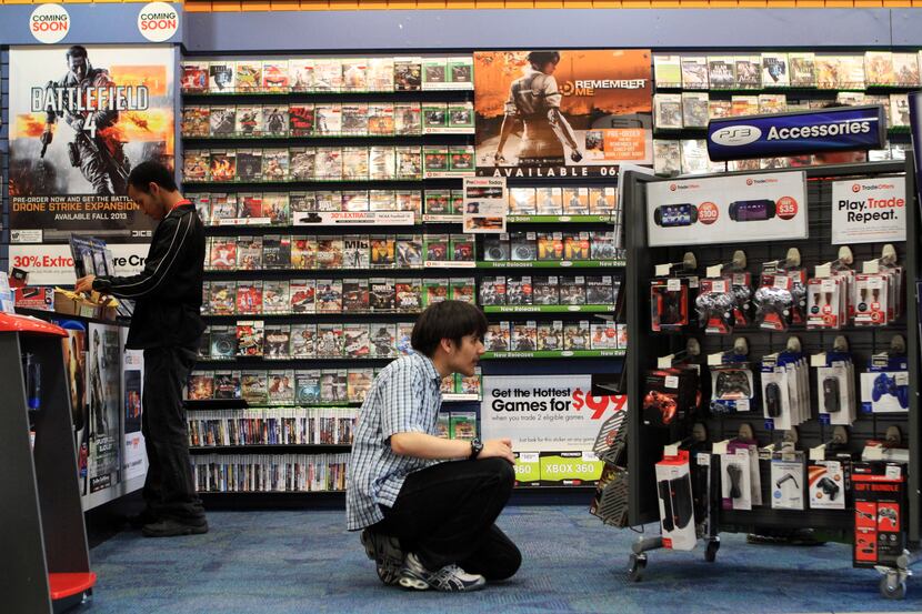 Moises Flores, 17, browses video games at the GameStop store at NorthPark Center, on May 23,...