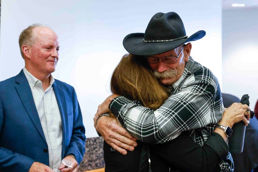Dan Probst (right) embraces Loren Smith Adair, daughter of alleged victim Phyllis Payne as...
