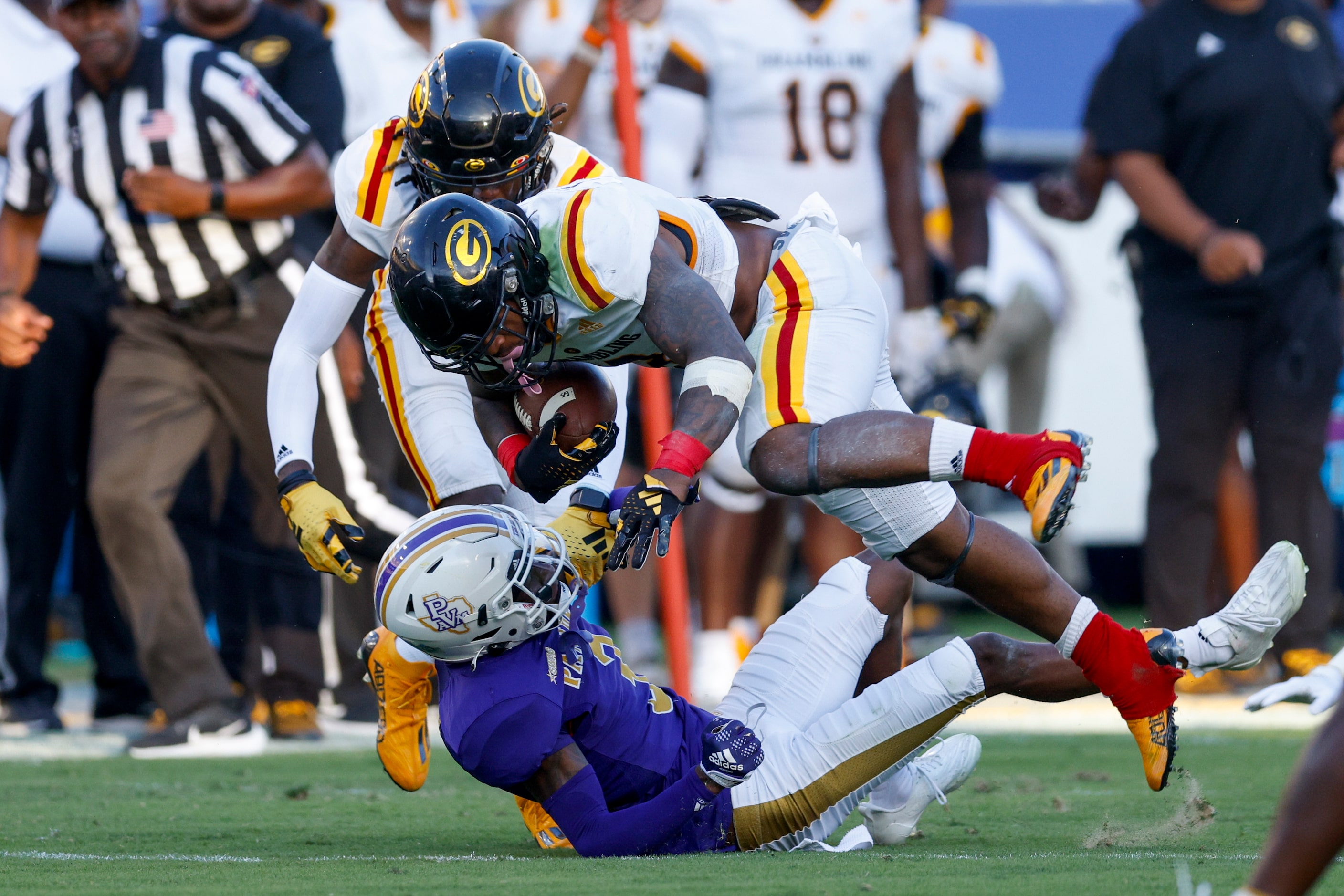 Grambling State running back Floyd Chalk IV (3) runs through the tackle of Prairie View A&M...