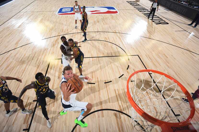 Orlando, FL - JULY 26: Luka Doncic #77 of the Dallas Mavericks shoots the ball against the...