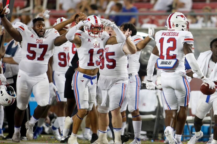 SMU safety Isaiah Nwokobia (12), right, ignites the Mustangs sidelines after intercepting a...
