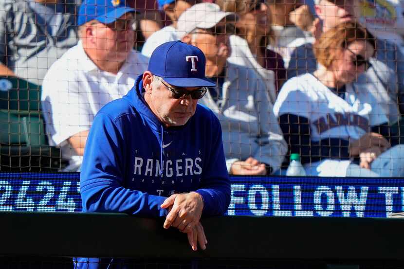 Texas Rangers manager Bruce Bochy looks down from the dugout railing as they trail the...