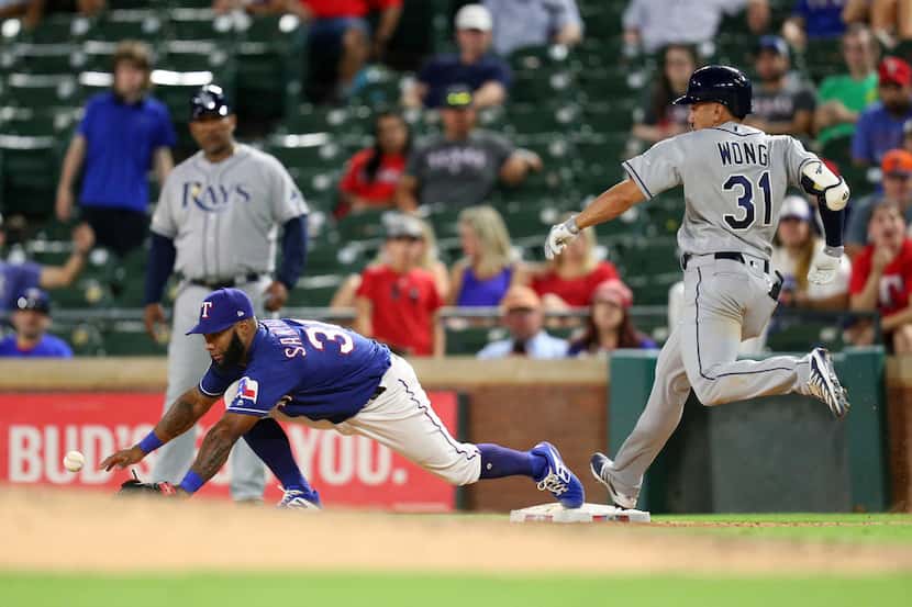 Texas Rangers' second baseman Danny Santana (38) comes off the bag to reach the ball thrown...