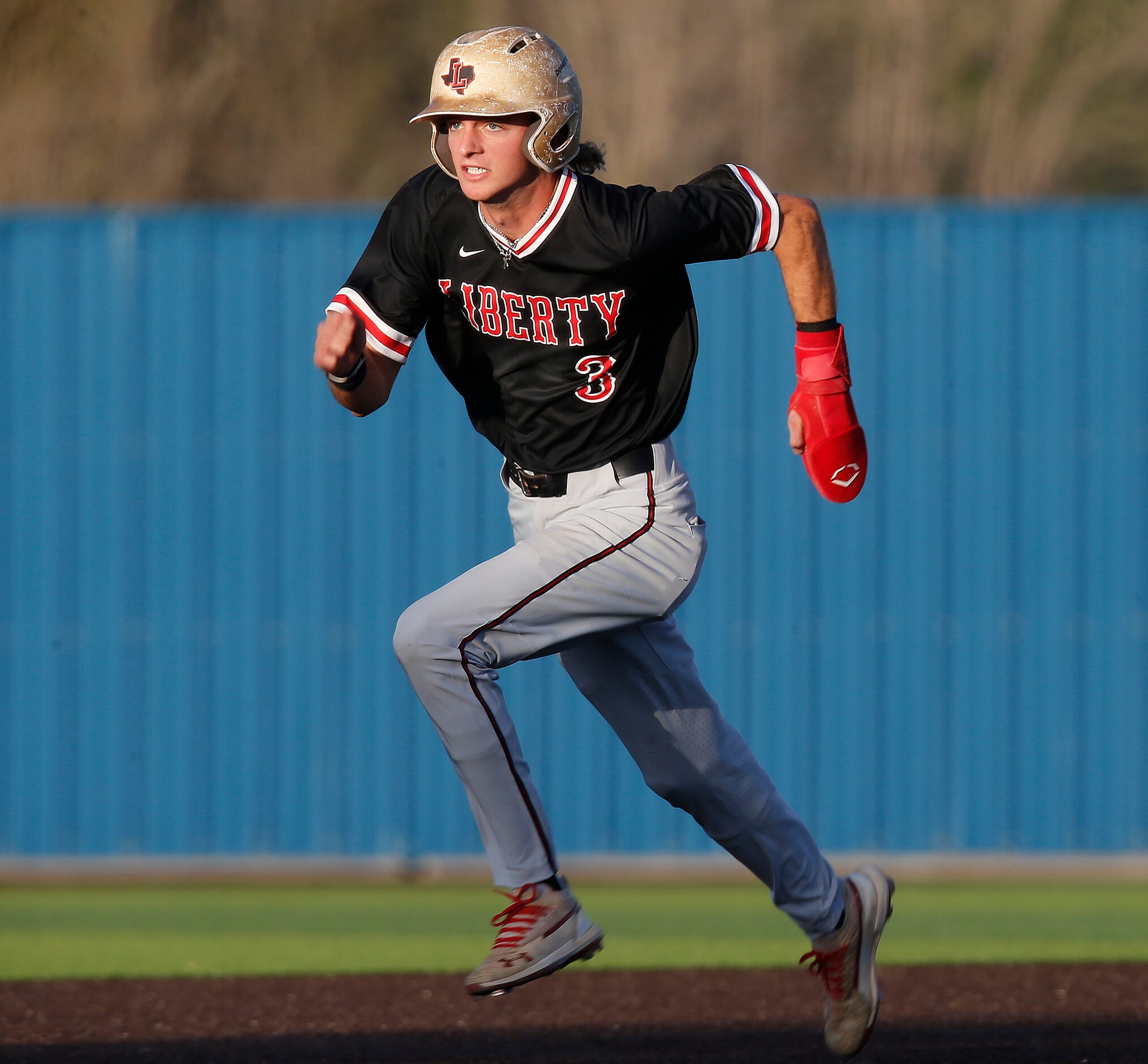 Liberty shortstop Cade McGarrh heads to third base on his way to scorring the game’s first...