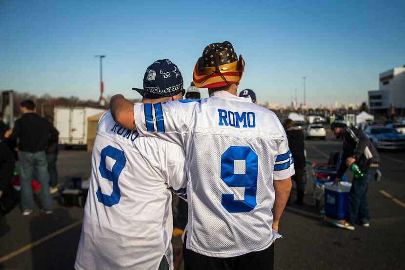 Fans pose for a photo while tailgating before an NFL football game at Lincoln Financial...