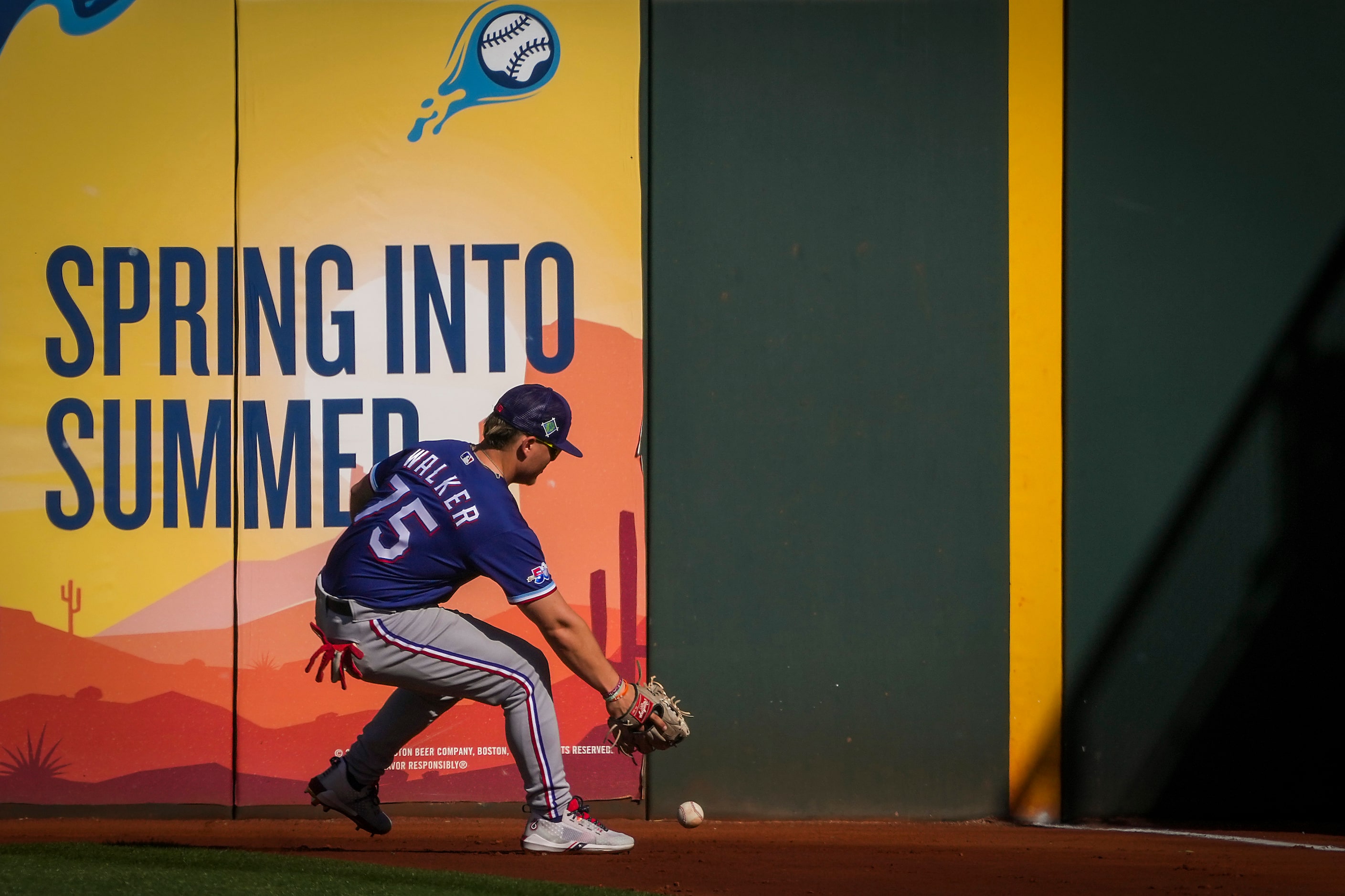 Texas Rangers outfielder Steele Walker chases a double off the bat of the Cleveland...