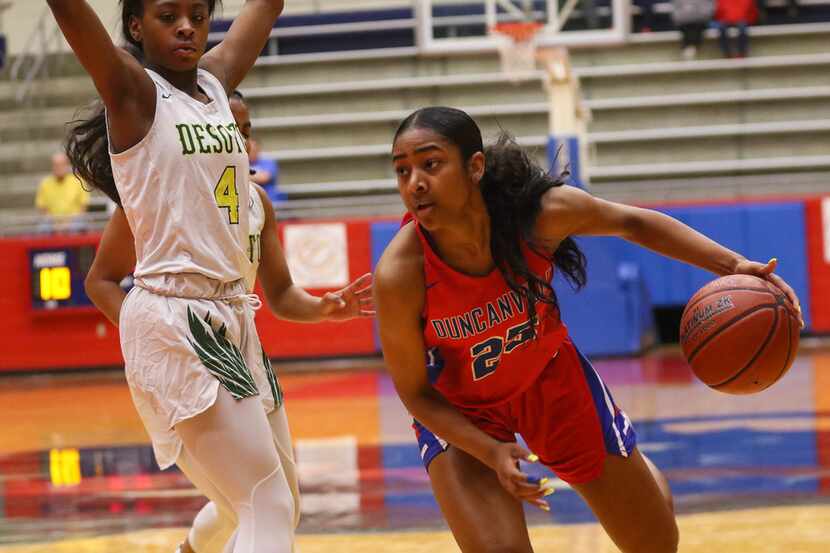 McDonald's All-American Deja Kelly (right) of Duncanville drives the ball during a 66-47...