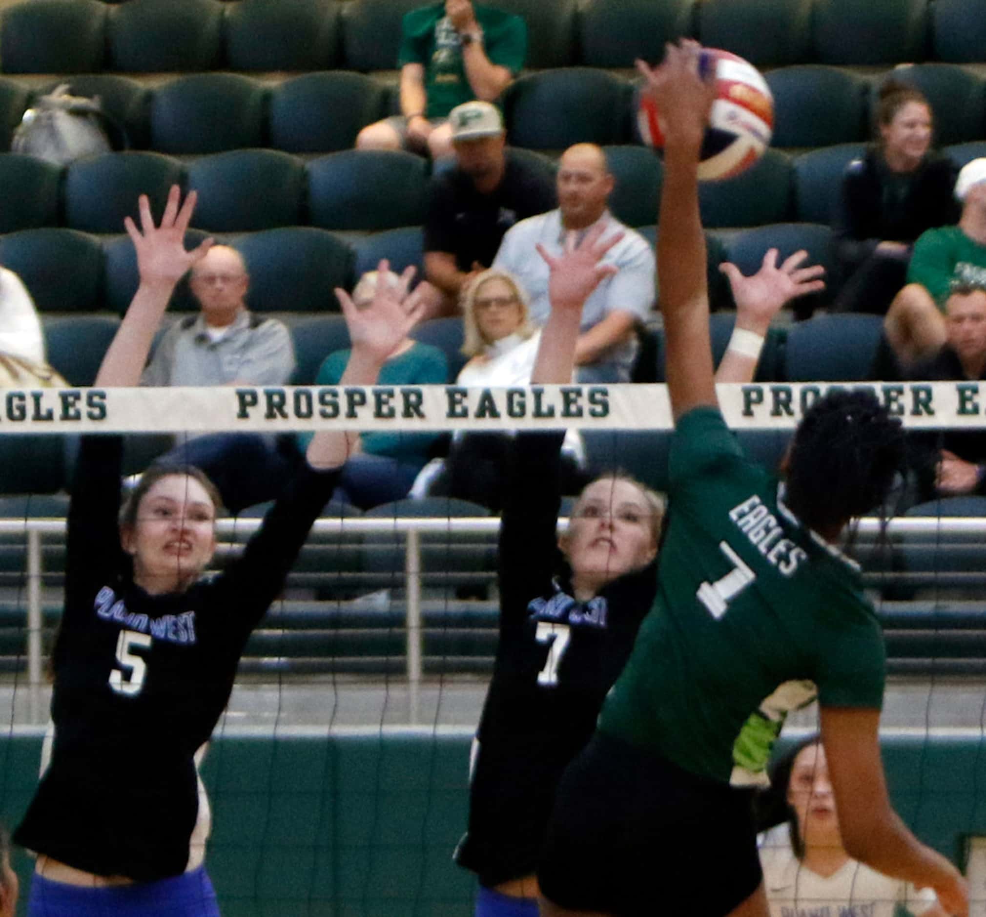 Prosper's Bailey Birmingham (7) powers a spike past the defense of Plano West defenders...
