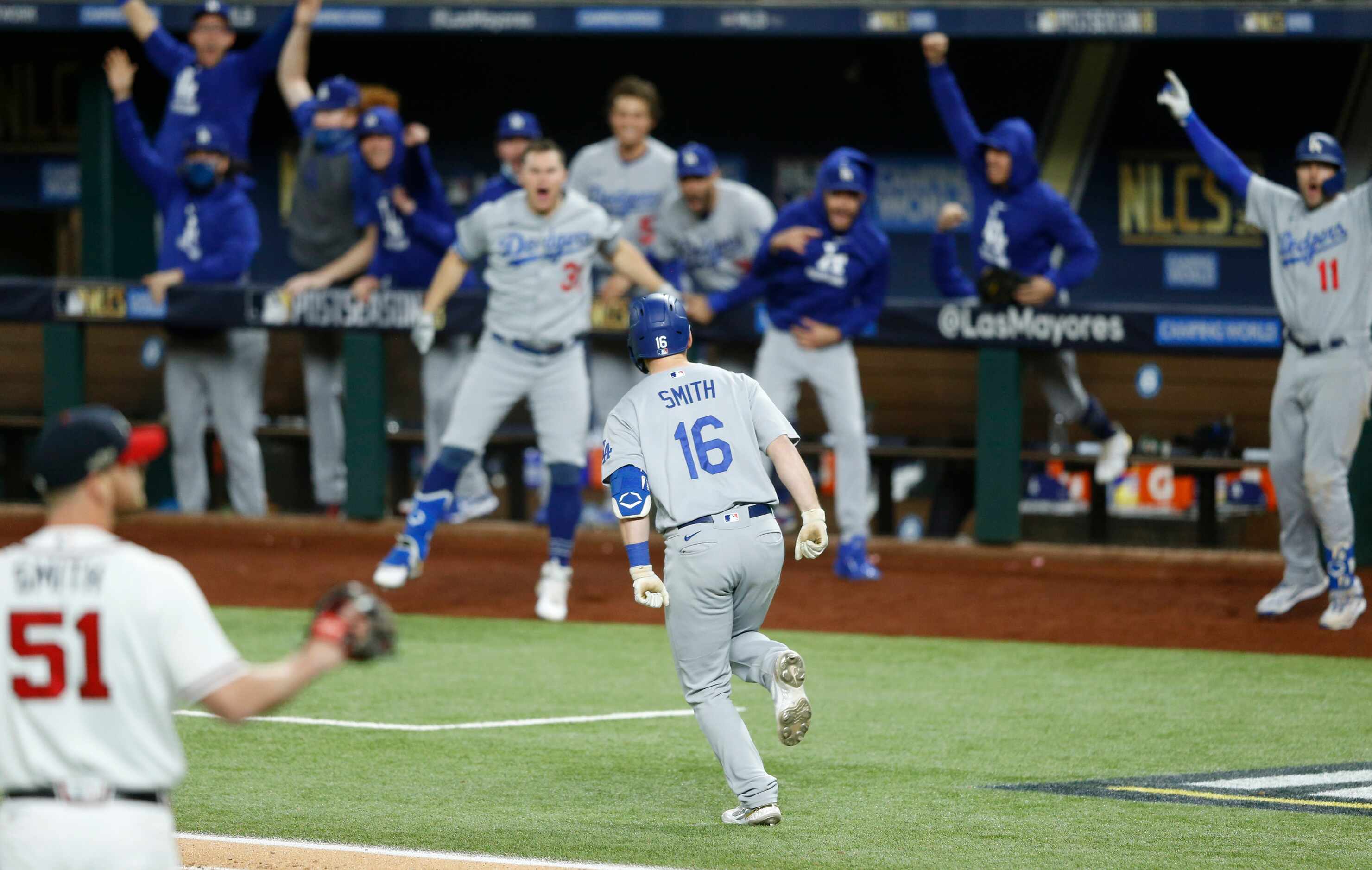 Los Angeles Dodgers catcher Will Smith (16) celebrates with teammates as he rounds the bases...