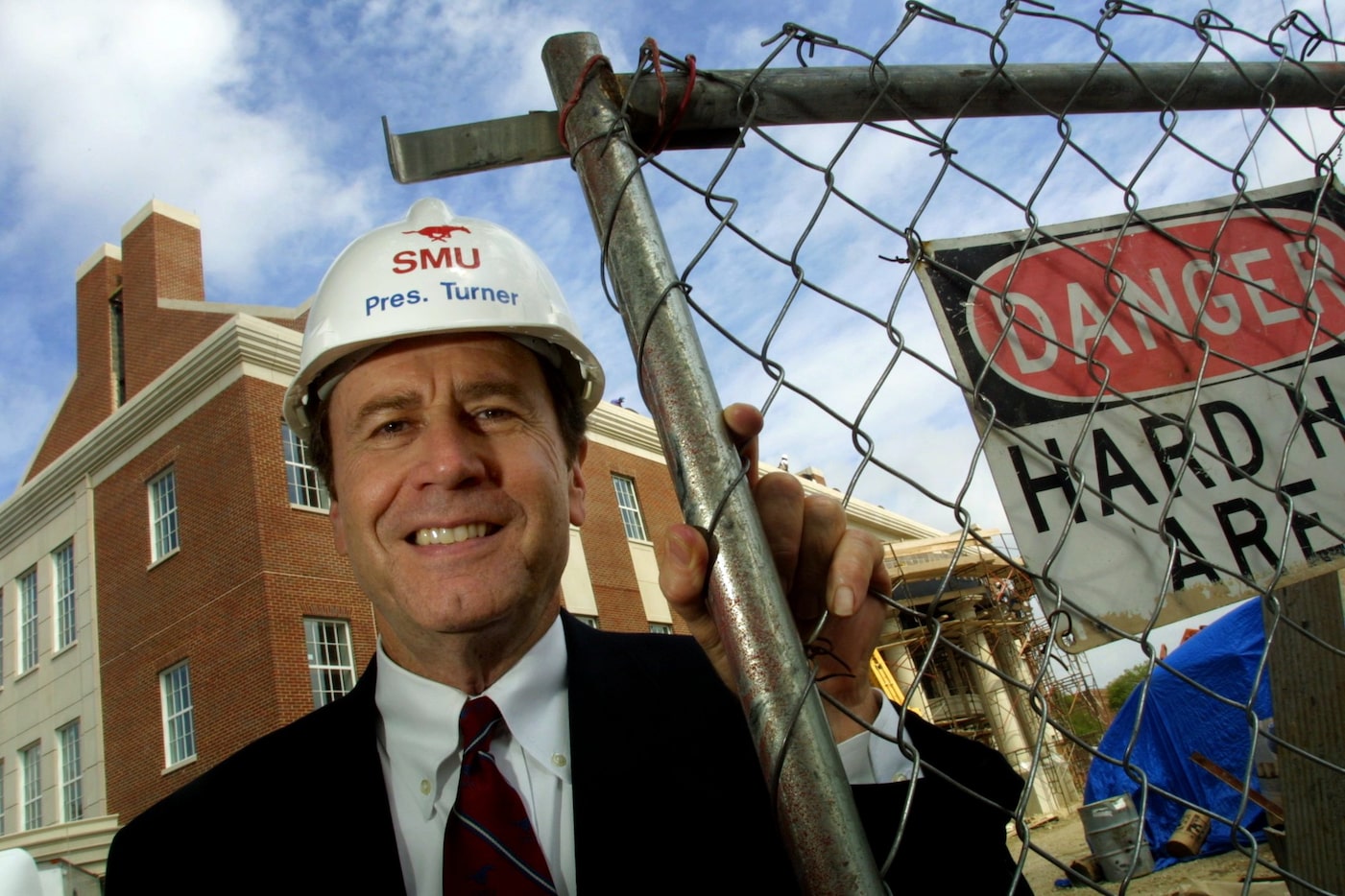 SMU President R. Gerald Turner in front of the Jerry R. Junkins Electrical Engineering...