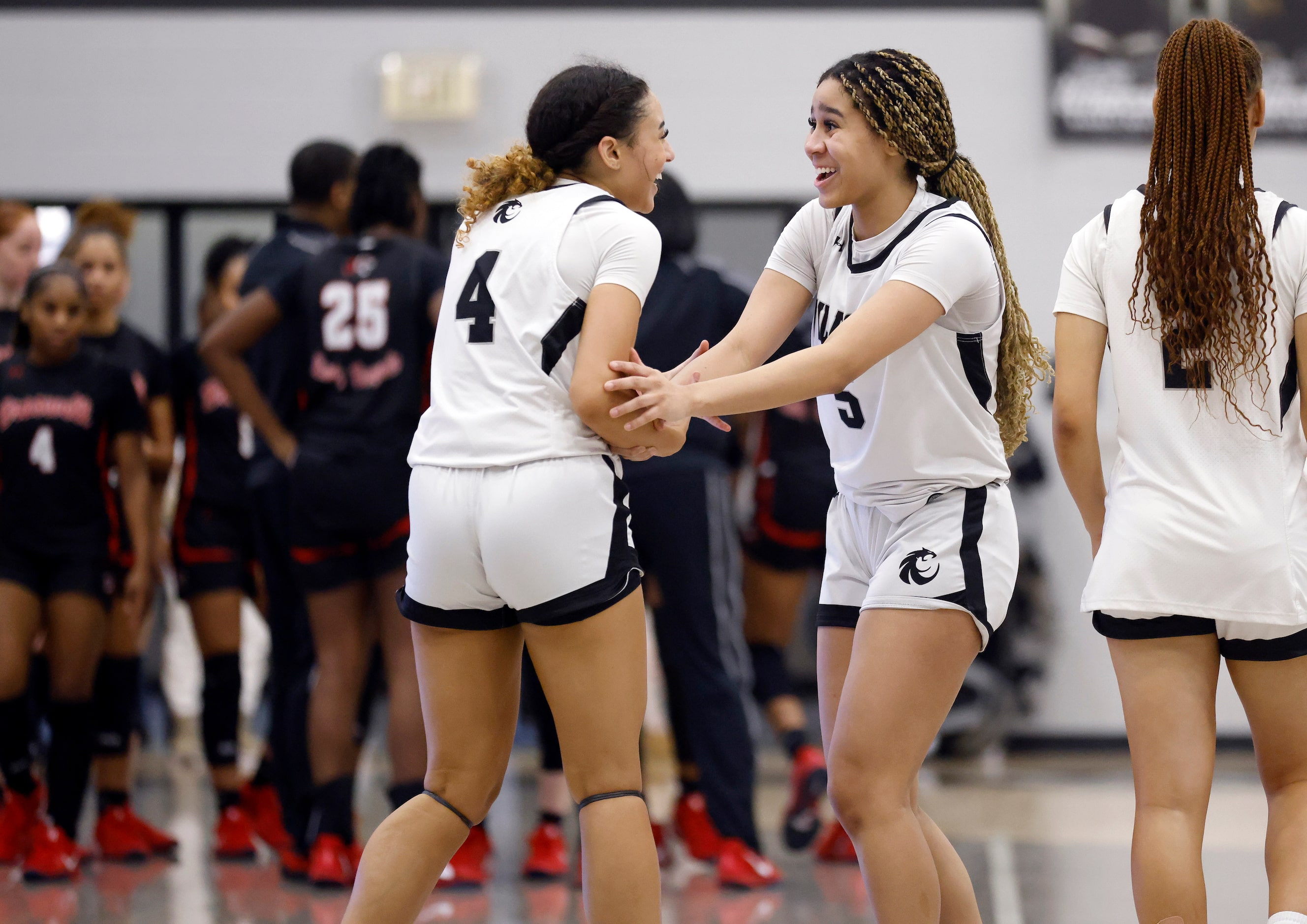 Denton Guyer’s Baylee Bowman (4) and Amaya Langford (5) celebrate their 49-47 win over...