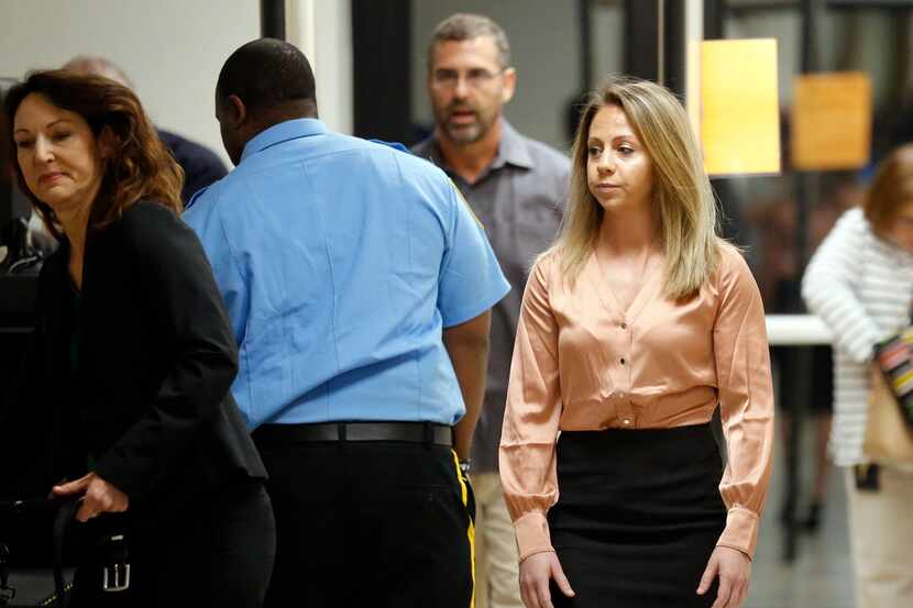 Amber Guyger (right) arrives at the Dallas courthouse during jury selection Friday for her...