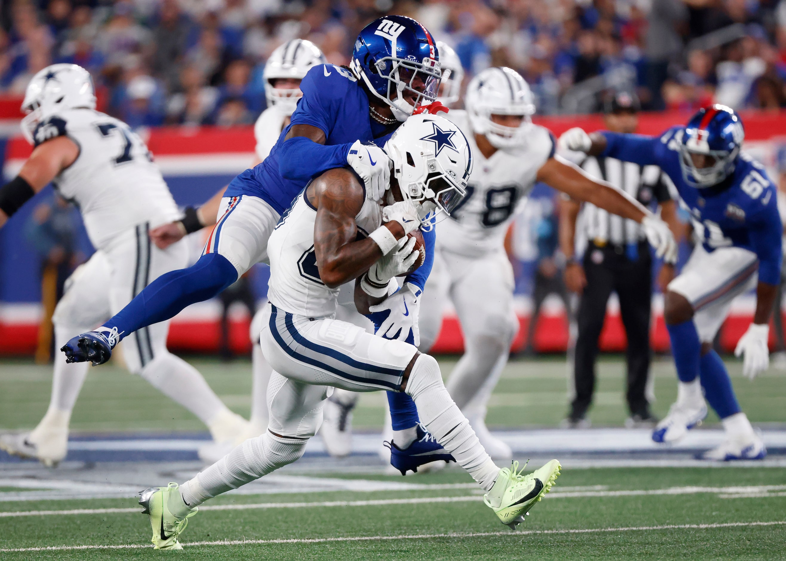 New York Giants cornerback Deonte Banks (3) rides Dallas Cowboys wide receiver CeeDee Lamb...