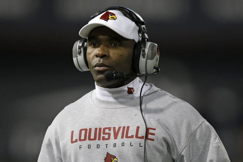 Louisville head coach Charlie Strong watches from the sidelines in the first half of an NCAA...