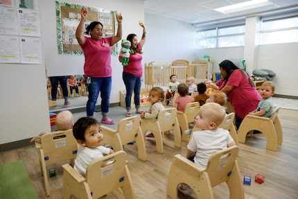 Caregivers Claudel Lepe (left) and Shyela Gonzaga (center) lead a song for infants at Little...