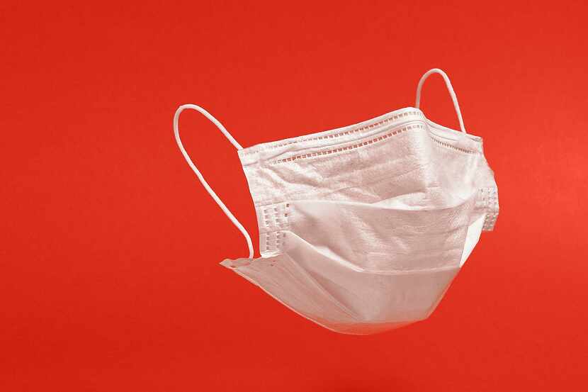 Surgical face mask on red background