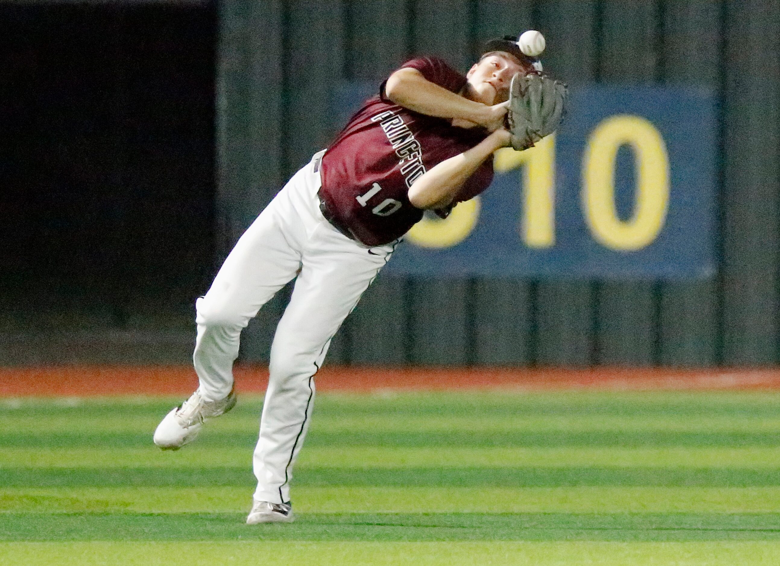 Princeton High School shortstop Chad Kyle (10) was able to hang on for the catch and the out...