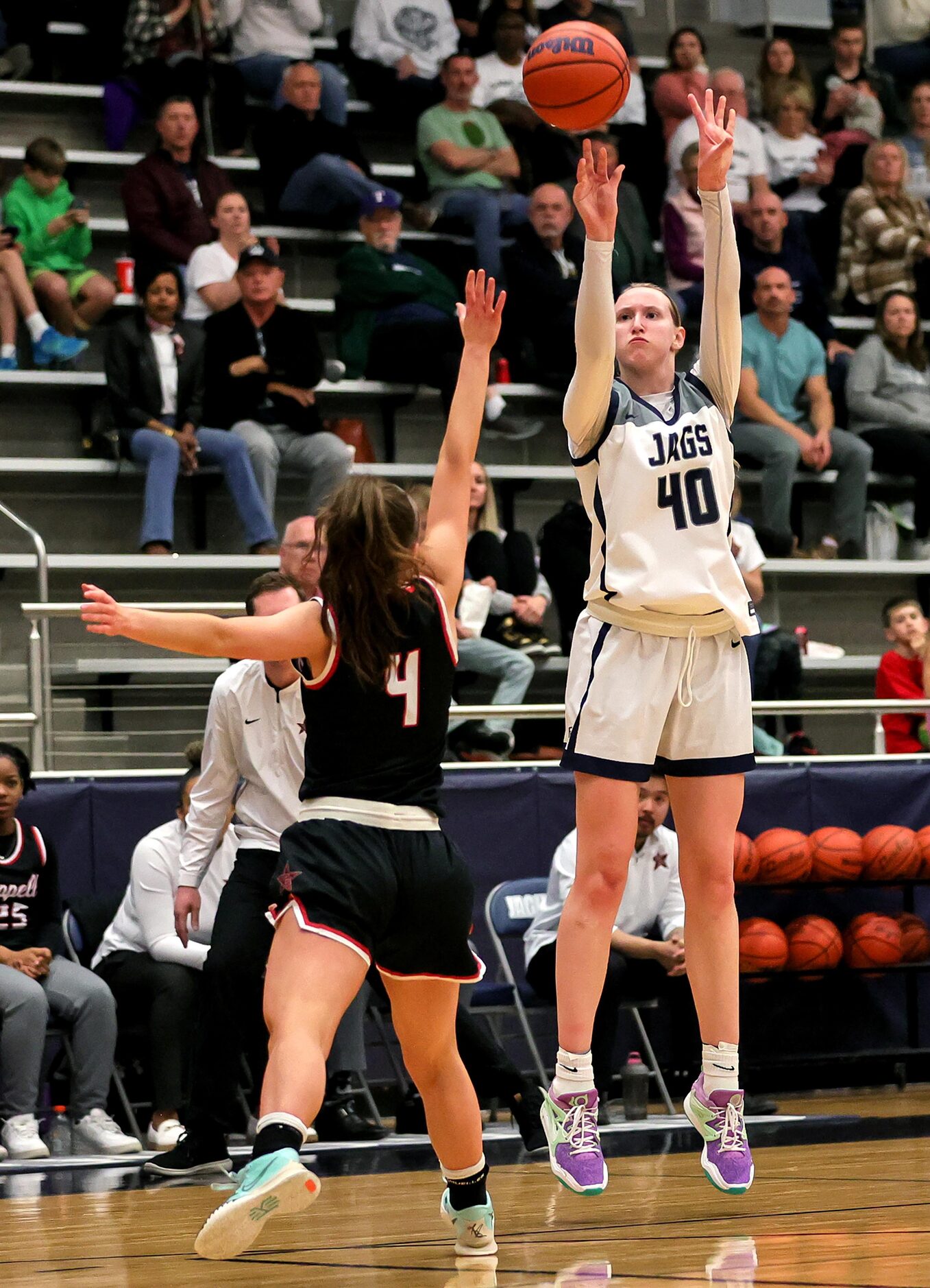 Flower Mound guard Madison Cox (40) attempts a three point shot over Coppell guard Allyssa...