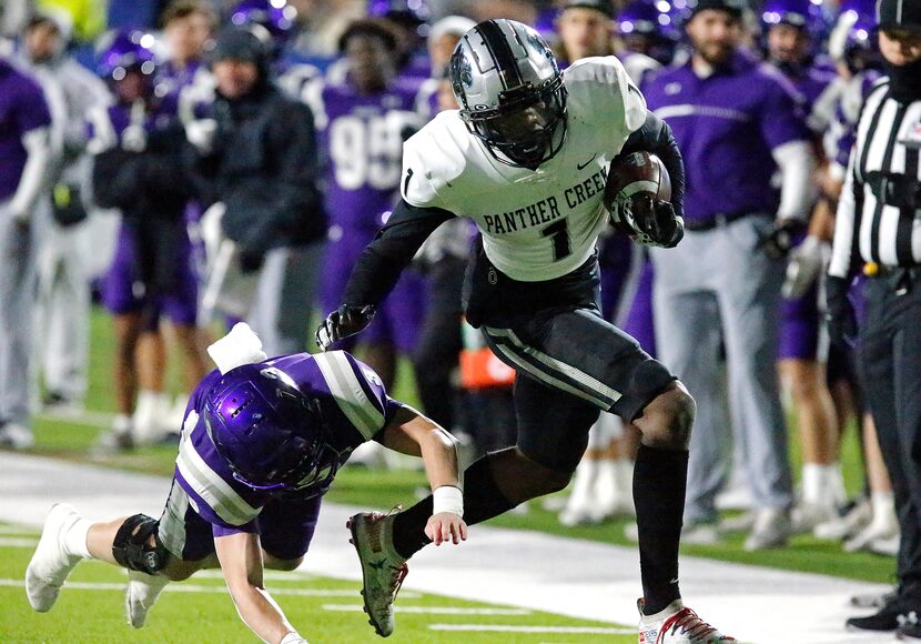 Panther Creek High School running back Sentel Simpson (1) is bumped out of bounds by Anna...